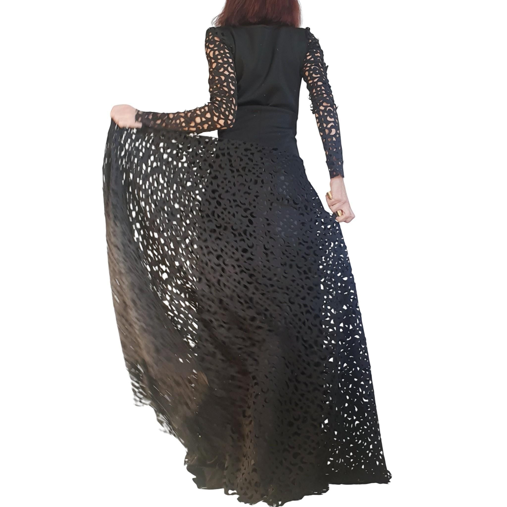 Black polyester neoprene maxi skirt dress with intricate cut-out details and long sleeves. dreSSShoescode.