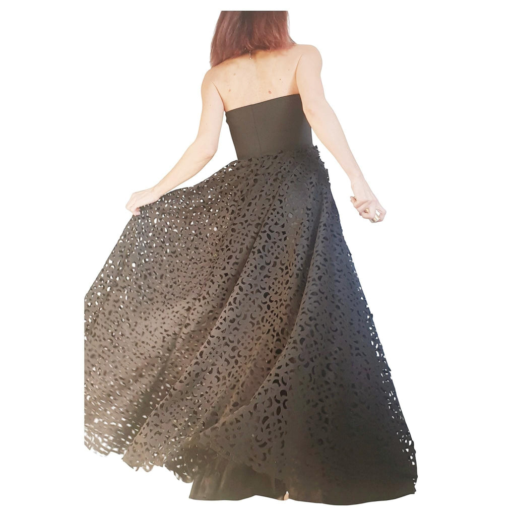Black strapless maxi skirt dress with intricate laser-cut floral pattern, polyester neoprene. dreSSShoescode.