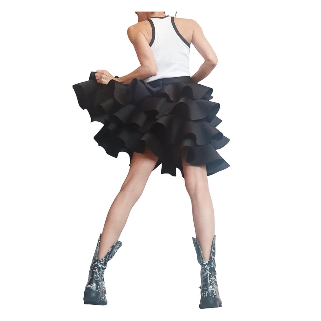 dreSSShoescode black neoprene and polyester ruffled circle skirt with asymmetric hem, worn by a model.