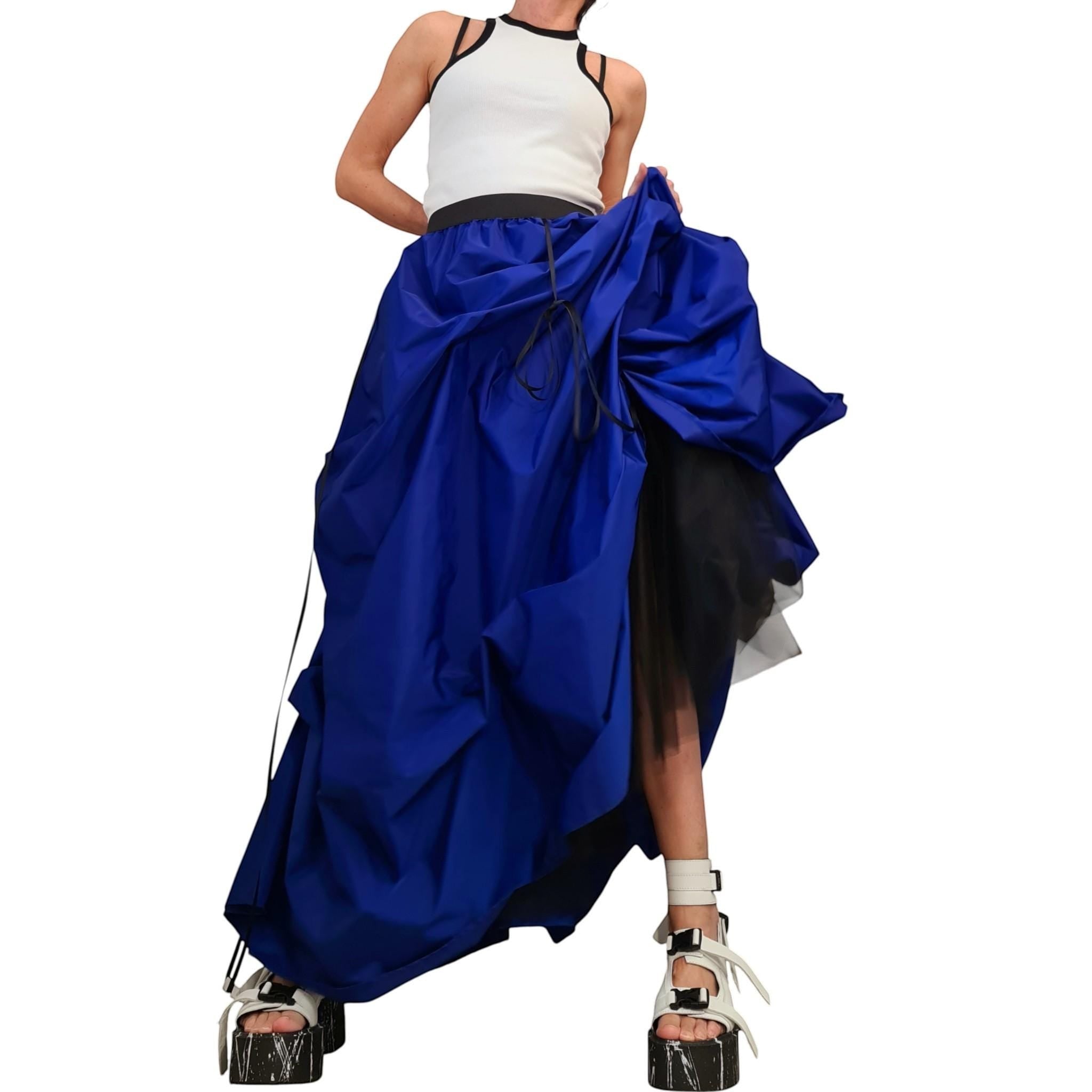 dreSSShoescode royal blue asymmetric tulle ball skirt with black underskirt, worn by a model with white tank top and platform sandals.