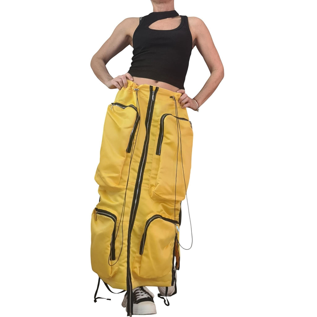dreSSShoescode Yellow cotton satin maxi skirt with cargo pockets and black zipper accents. Avant-garde deconstructed silhouette.